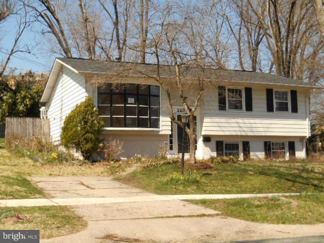 12718 Bushey Drive Silver Spring, MD 20906 - Photo 1 of 19 a front view of a house with a yard