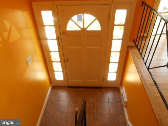 12718 Bushey Drive Silver Spring, MD 20906 - Photo 2 of 19 a view of empty room with wooden floor and fan