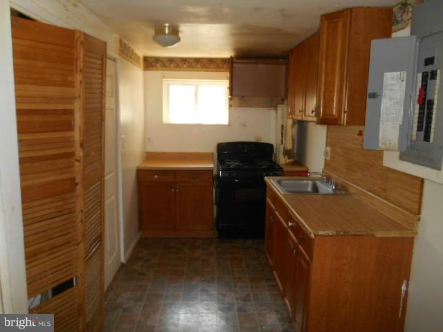 12718 Bushey Drive Silver Spring, MD 20906 - Photo 12 of 19 a kitchen with a sink stove and refrigerator