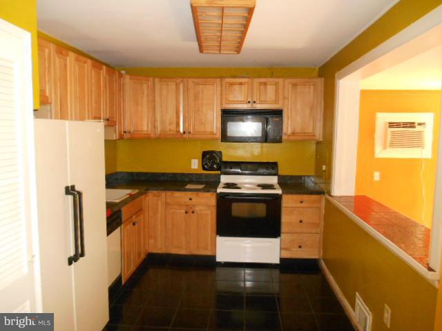 12718 Bushey Drive Silver Spring, MD 20906 - Photo 3 of 19 a kitchen with stainless steel appliances a stove microwave and refrigerator