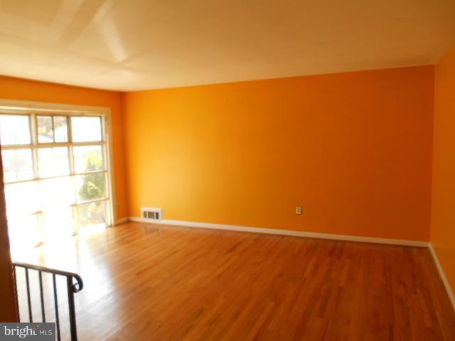 12718 Bushey Drive Silver Spring, MD 20906 - Photo 4 of 19 a view of an empty room with wooden floor and a window