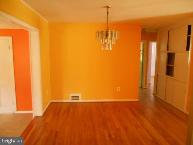 12718 Bushey Drive Silver Spring, MD 20906 - Photo 5 of 19 a view of a room with wooden floor and a window