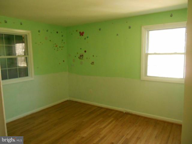 12718 Bushey Drive Silver Spring, MD 20906 - Photo 7 of 19 a view of a small space with wooden floor and a window