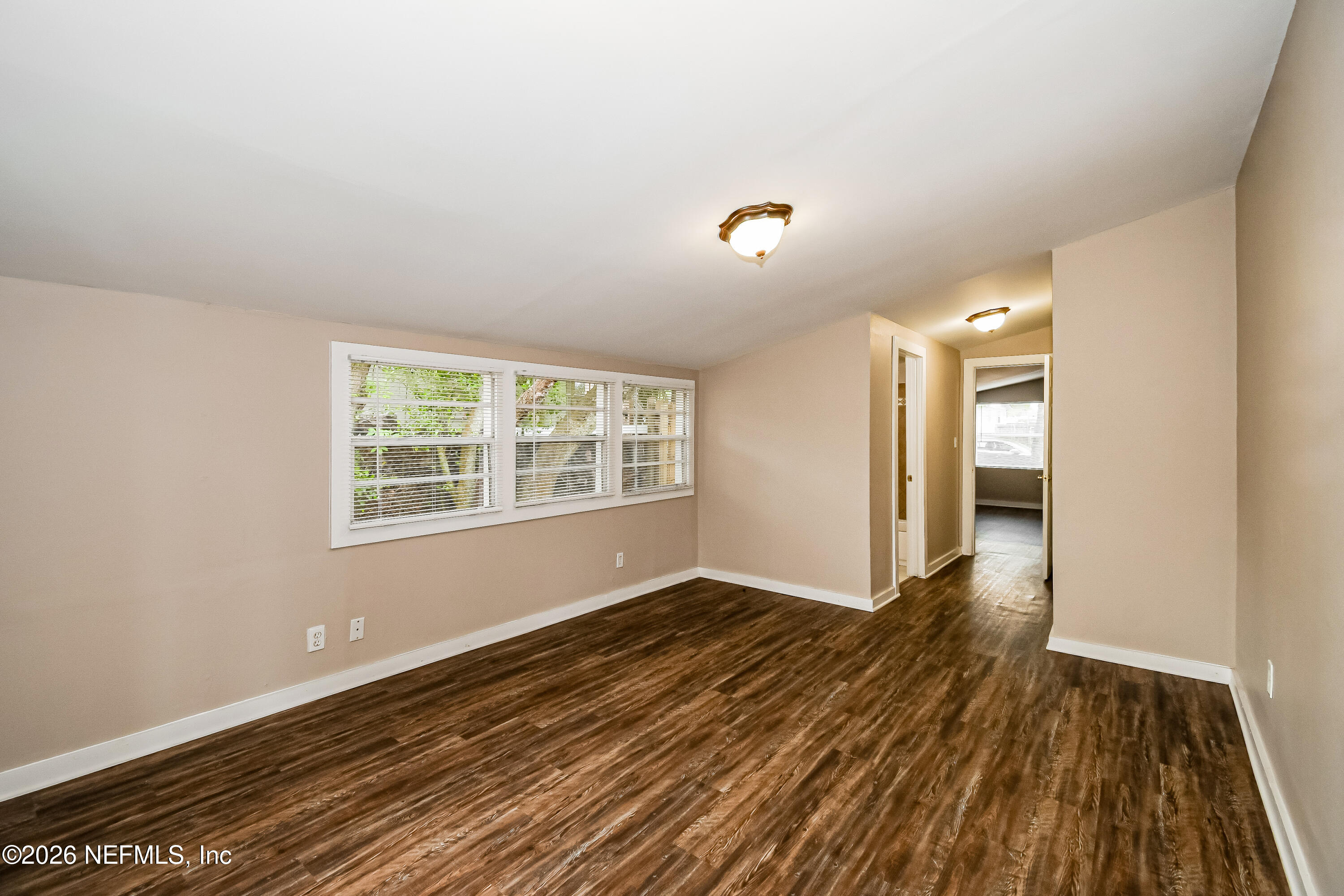 7227 Stonehurst Road North Jacksonville, FL 32277 - Photo 9 of 16 wooden floor in an empty room with a window