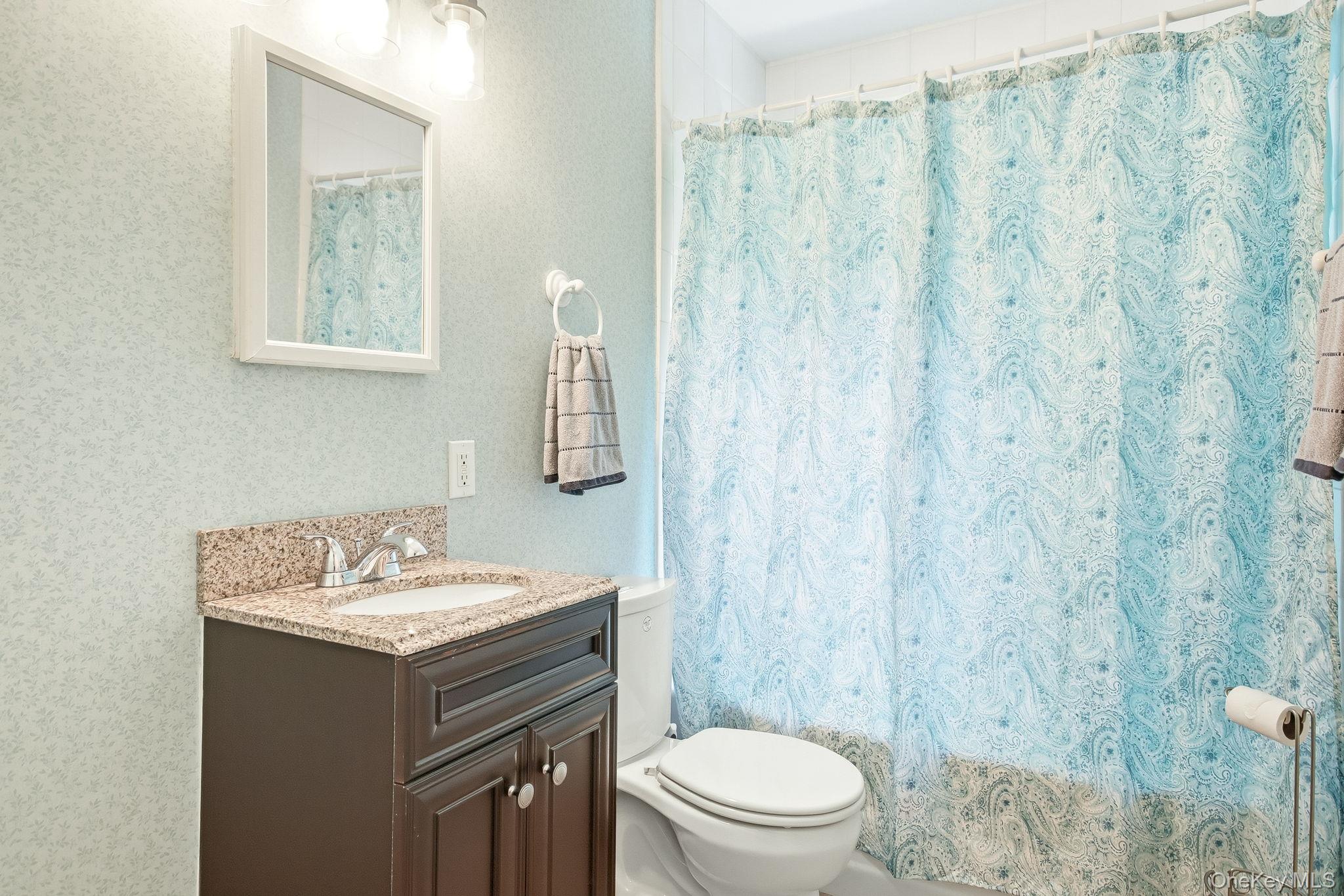 26 Century Ridge Road Purchase, NY 10577 - Photo 28 of 50 Lower level full bathroom featuring a dark wood-finish vanity with a stone countertop and sink (Bathroom #4)