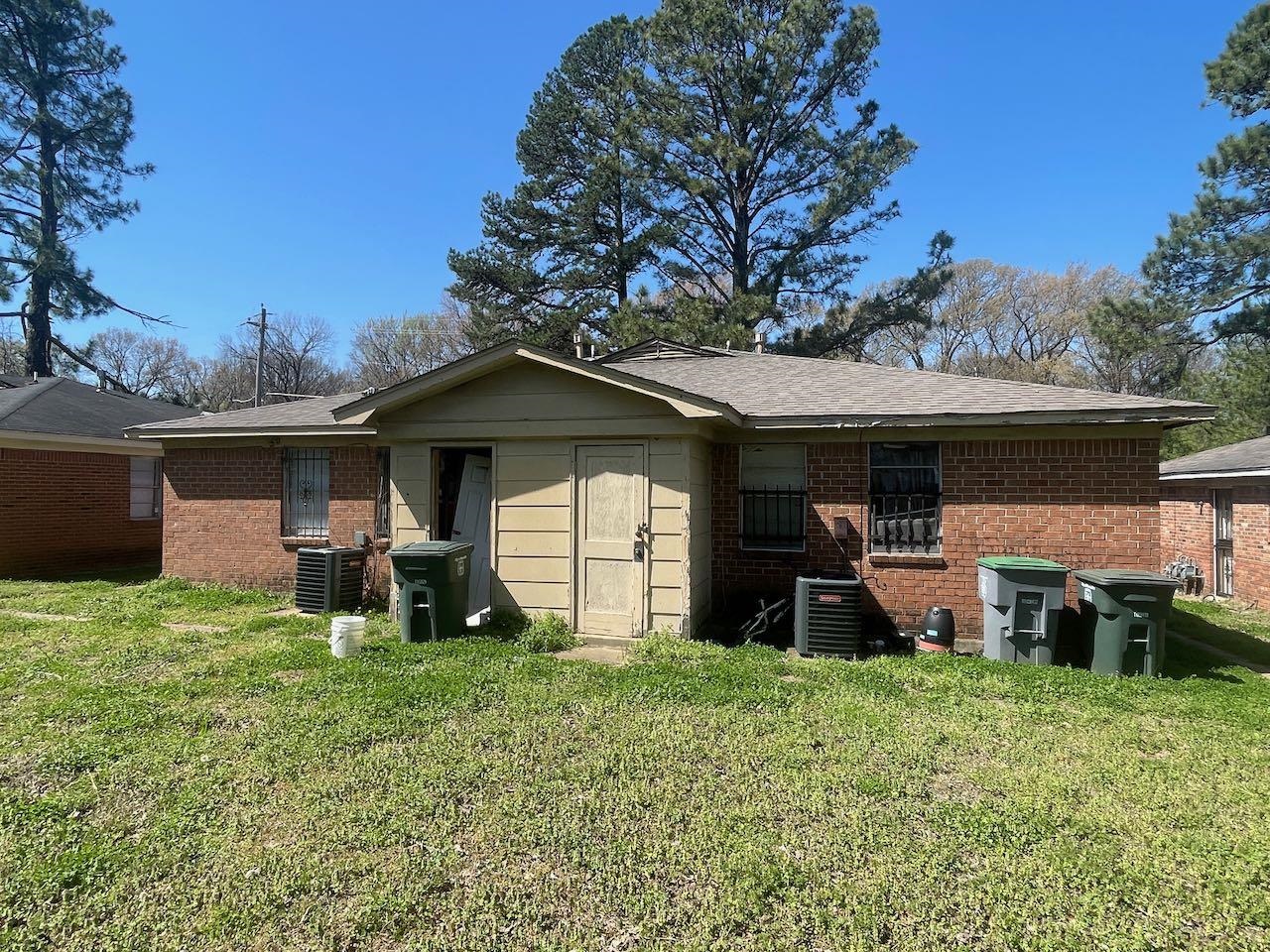 4460 Sumners Wells Road Memphis, TN 38118 - Photo 5 of 9 Back of house with brick siding, a yard, and a shingled roof