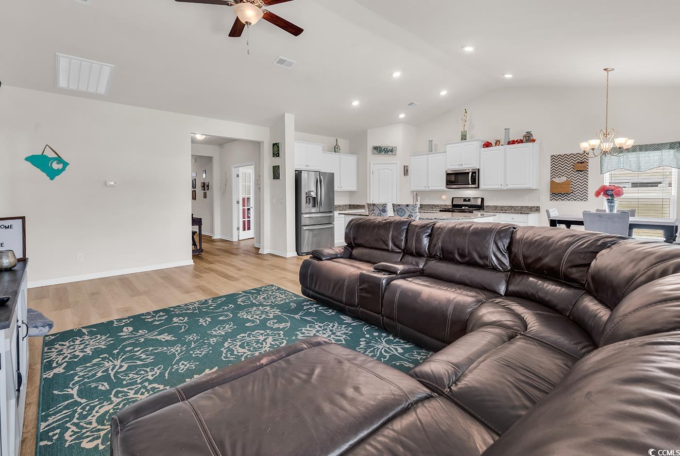 325 Cardita Loop Myrtle Beach, SC 29588 - Photo 20 of 39 Living room with a chandelier, ceiling fan, light