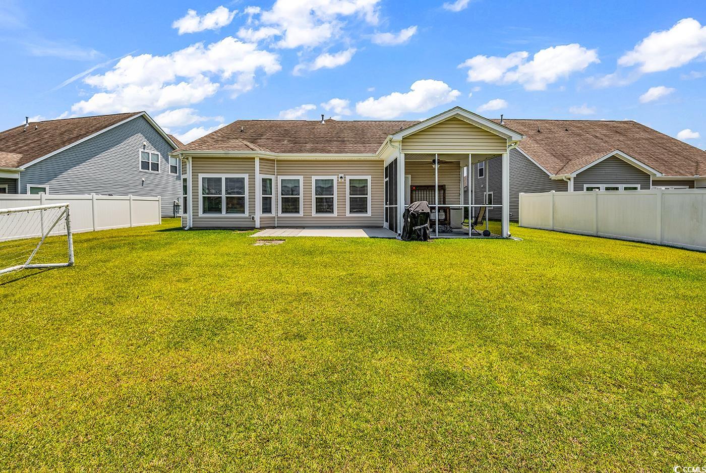 325 Cardita Loop Myrtle Beach, SC 29588 - Photo 33 of 39 Back of property with a fenced backyard, a sunroom