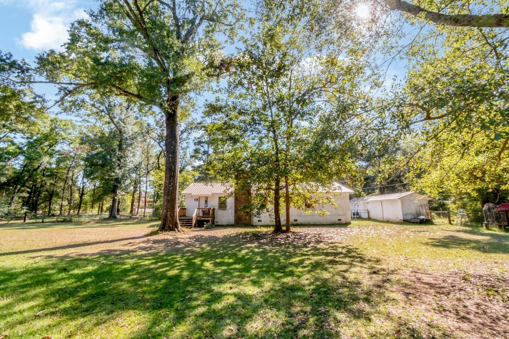 6405 1st Street Wilmer, AL 36587 - Photo 28 of 38 View of green lawn featuring a wooden deck and view of wooded area