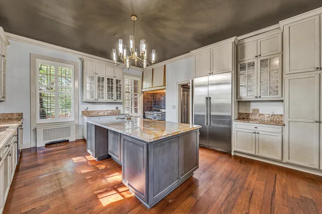 a view of a hallway with wooden floor and entryway