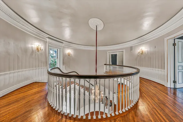 a front view of a house with a yard and shrubs