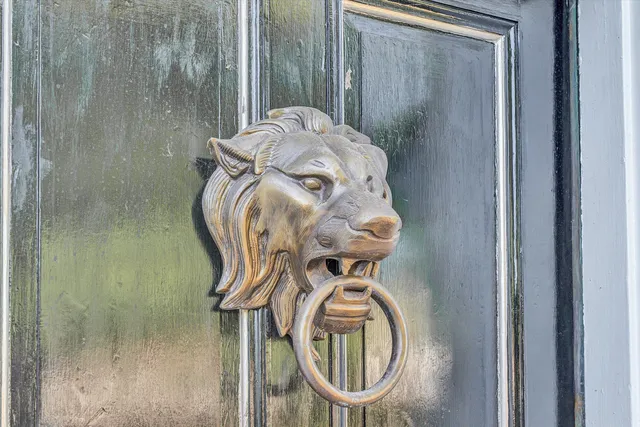 a kitchen with a stove and a wooden floor