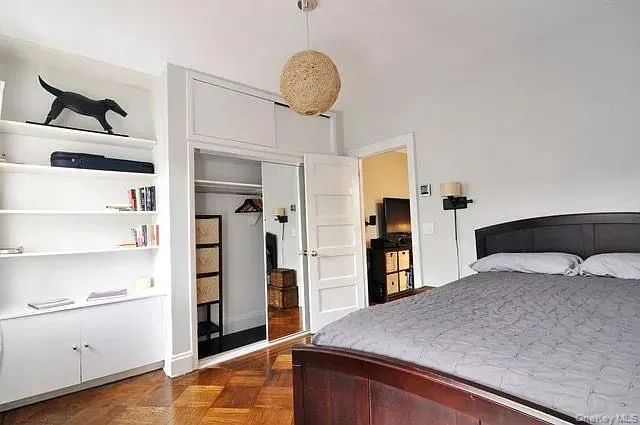 a bedroom with a bed and cabinets
