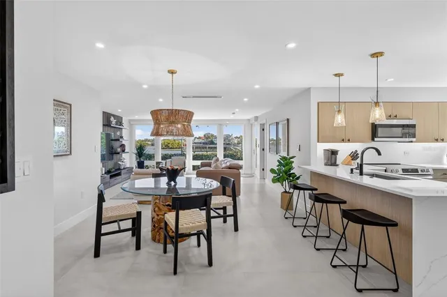 a kitchen with stainless steel appliances granite countertop a refrigerator and a sink