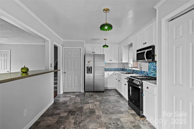 a kitchen with refrigerator and natural light