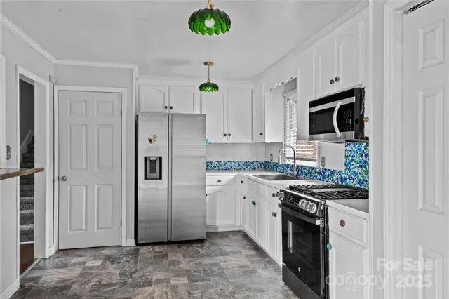 a kitchen with stainless steel appliances a refrigerator stove and microwave