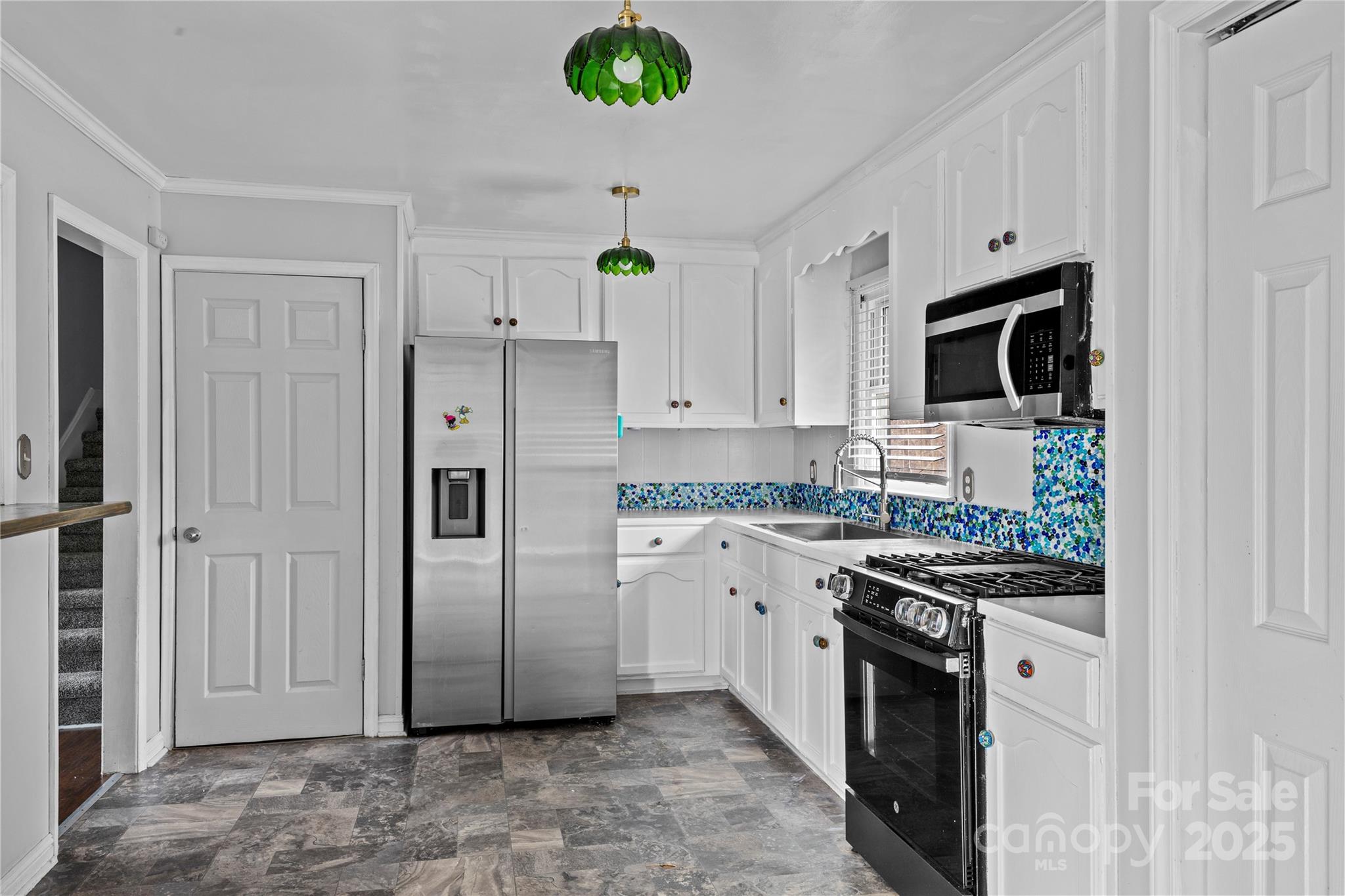 102 Wingate Drive Stanley, NC 28164 - Photo 15 of 37 a kitchen with stainless steel appliances a refrigerator stove and microwave