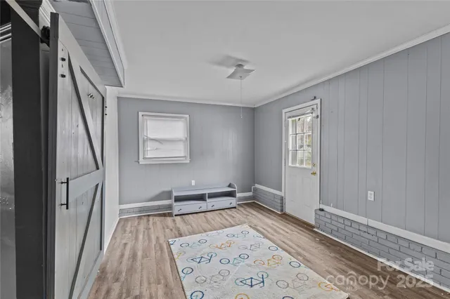 a view of hallway with wooden floor