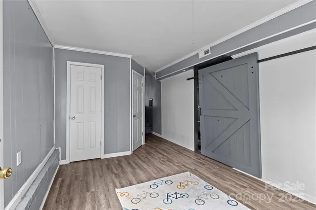 a view of hallway with wooden floor