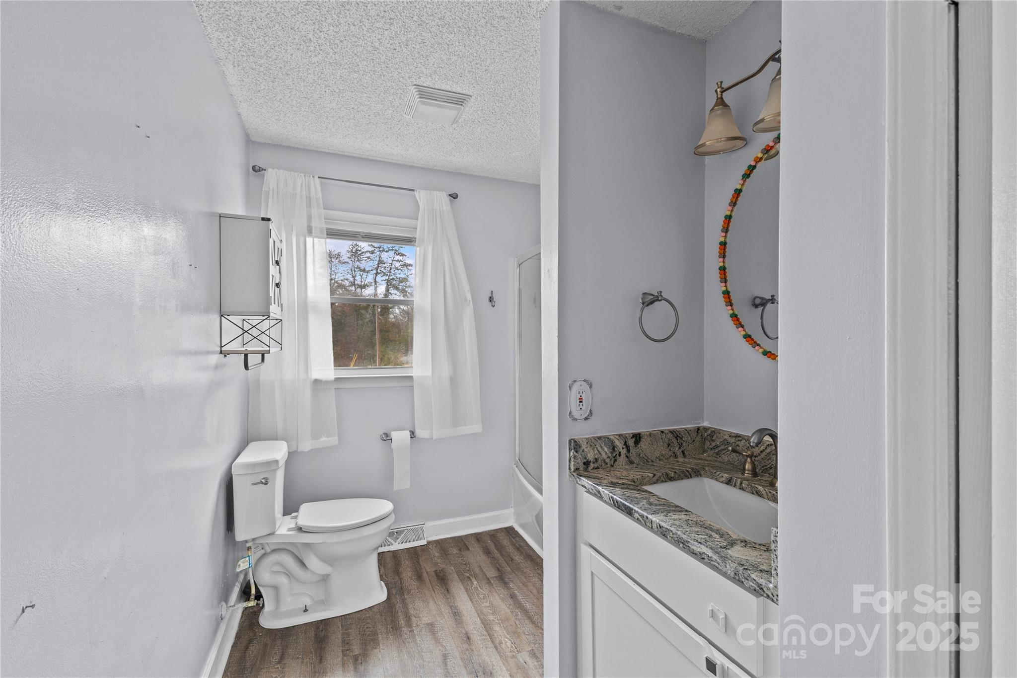 102 Wingate Drive Stanley, NC 28164 - Photo 33 of 37 a bathroom with a granite countertop sink toilet and shower