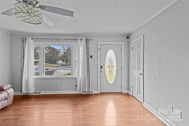 a view of room with window and wooden floor