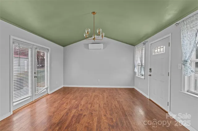 a view of a room with wooden floor and windows