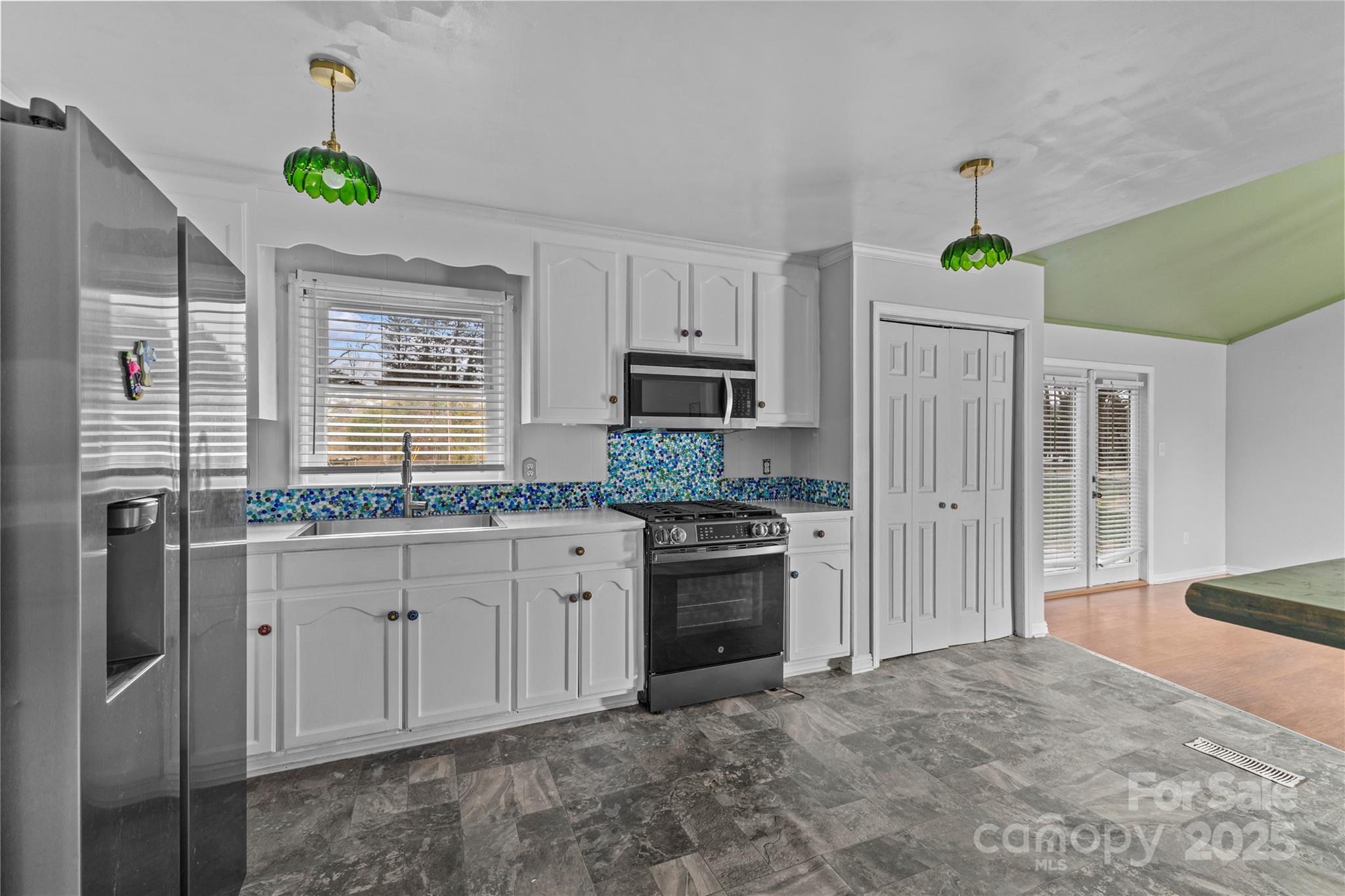 102 Wingate Drive Stanley, NC 28164 - Photo 10 of 37 a kitchen with granite countertop a sink stainless steel appliances and cabinets
