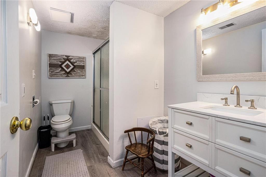 4034 Beaver Road Southwest Loganville, GA 30052 - Photo 13 of 24 a bathroom with a toilet a sink and mirror