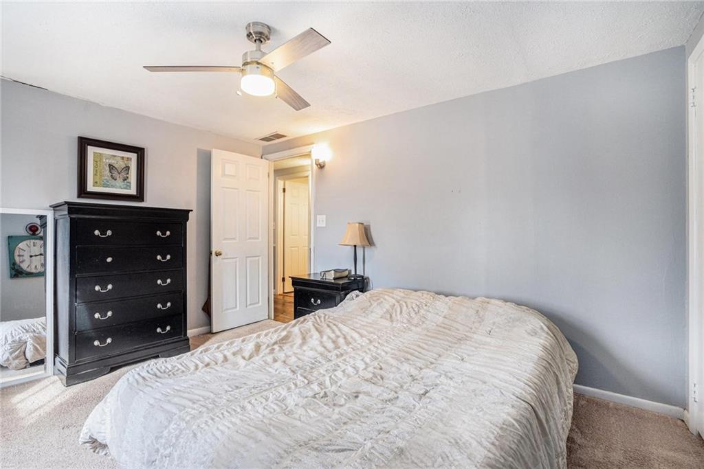 4034 Beaver Road Southwest Loganville, GA 30052 - Photo 15 of 24 a bedroom with a bed and a chandelier