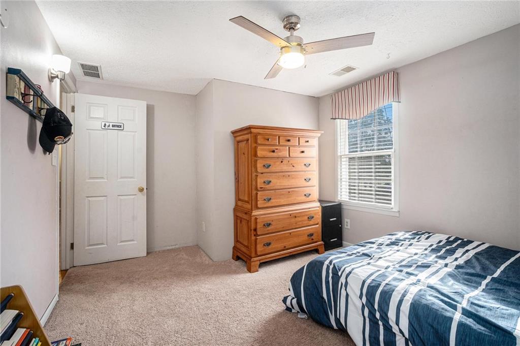 4034 Beaver Road Southwest Loganville, GA 30052 - Photo 17 of 24 a bedroom with a bed and a ceiling fan