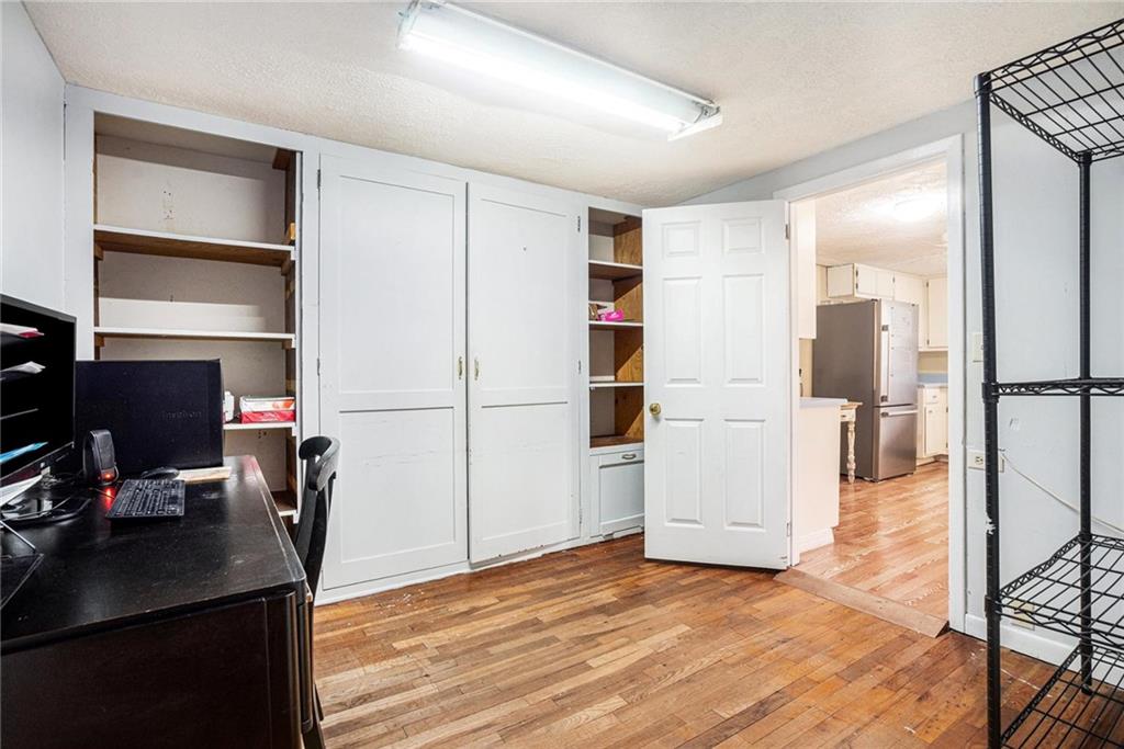 4034 Beaver Road Southwest Loganville, GA 30052 - Photo 18 of 24 a view of a workspace with furniture and wooden floor