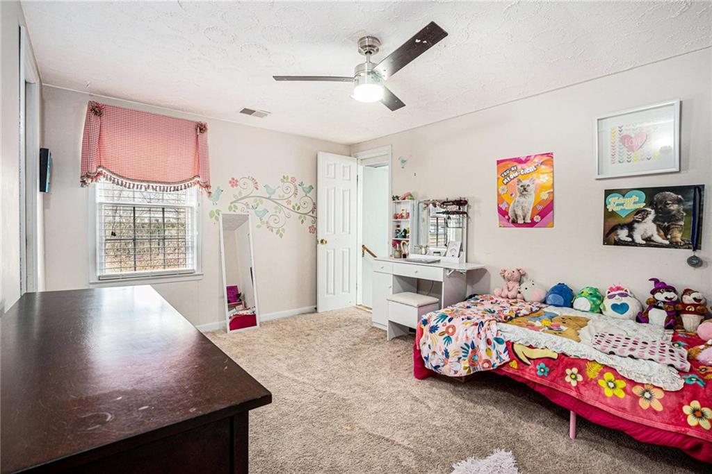4034 Beaver Road Southwest Loganville, GA 30052 - Photo 21 of 24 a bedroom with bed and a window