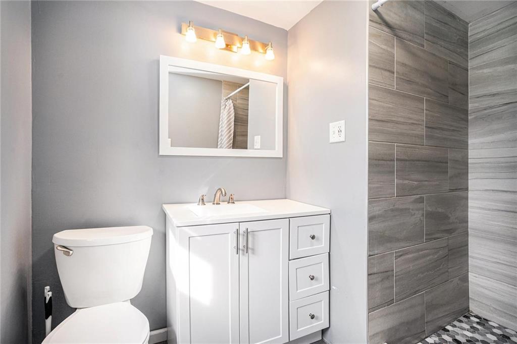 4034 Beaver Road Southwest Loganville, GA 30052 - Photo 3 of 24 a bathroom with a toilet a sink and mirror