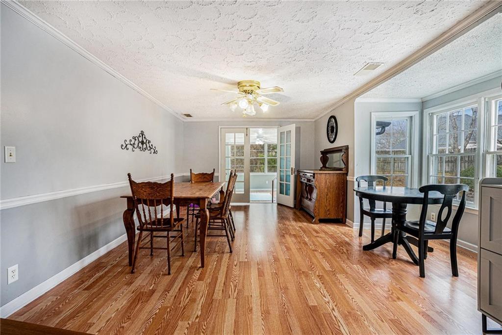 4034 Beaver Road Southwest Loganville, GA 30052 - Photo 5 of 24 a dining room with furniture a chandelier and wooden floor
