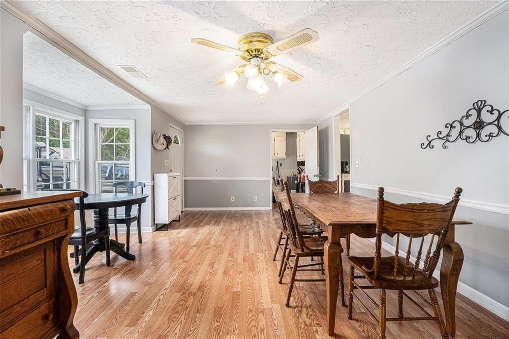 4034 Beaver Road Southwest Loganville, GA 30052 - Photo 9 of 24 a view of a dining room with furniture and wooden floor
