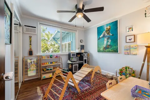 a living room with furniture a large window and a flat screen tv