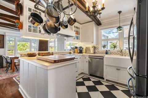 a kitchen with a sink a stove a microwave and cabinets