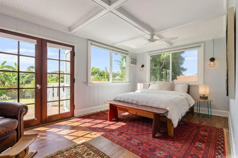 a bed sitting in a bedroom next to a window