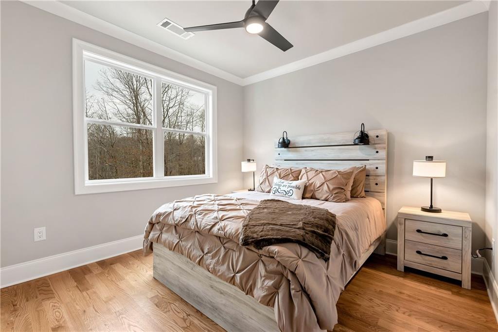 6140 Crescent Moon Ridge Cumming, GA 30041 - Photo 22 of 54 a bedroom with a bed and a tv
