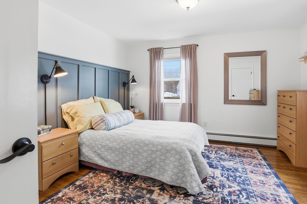 37 Sterling Street Lancaster, MA 01523 - Photo 14 of 33 a bedroom with a bed and wooden floor