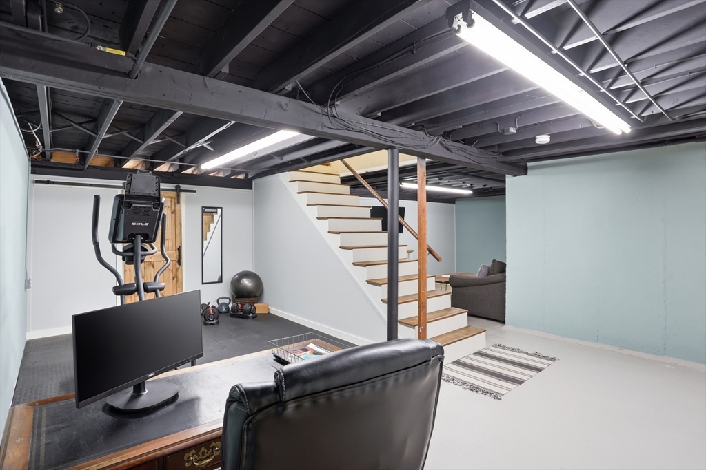 37 Sterling Street Lancaster, MA 01523 - Photo 23 of 33 a work room with wooden floor and furniture