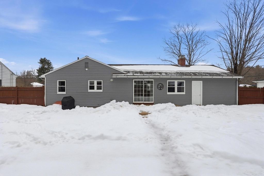 37 Sterling Street Lancaster, MA 01523 - Photo 26 of 33 a front view of a house with a yard covered in snow