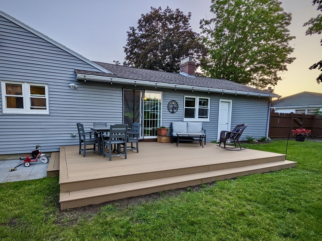 37 Sterling Street Lancaster, MA 01523 - Photo 30 of 33 a backyard of a house with wooden table and chairs