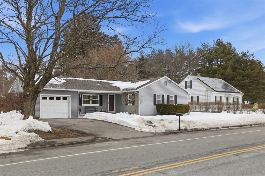 37 Sterling Street Lancaster, MA 01523 - Photo 3 of 33 a front view of a house with a yard covered in snow
