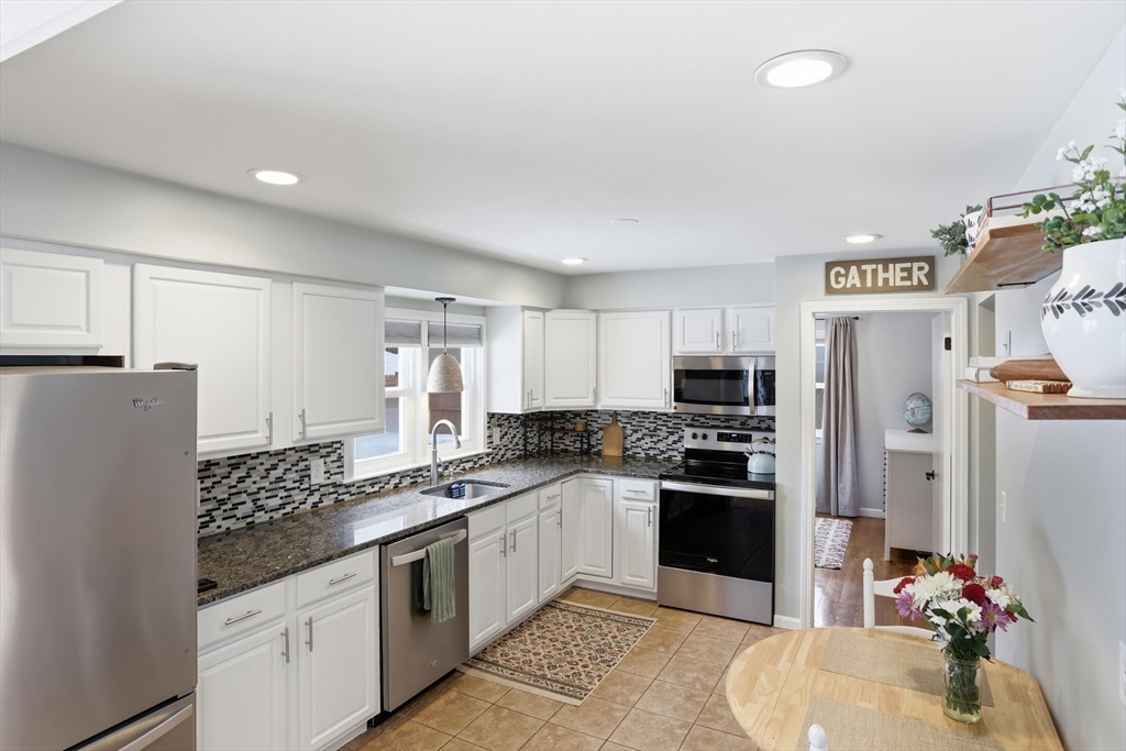 37 Sterling Street Lancaster, MA 01523 - Photo 8 of 33 a kitchen with stainless steel appliances granite countertop a refrigerator and a stove top oven