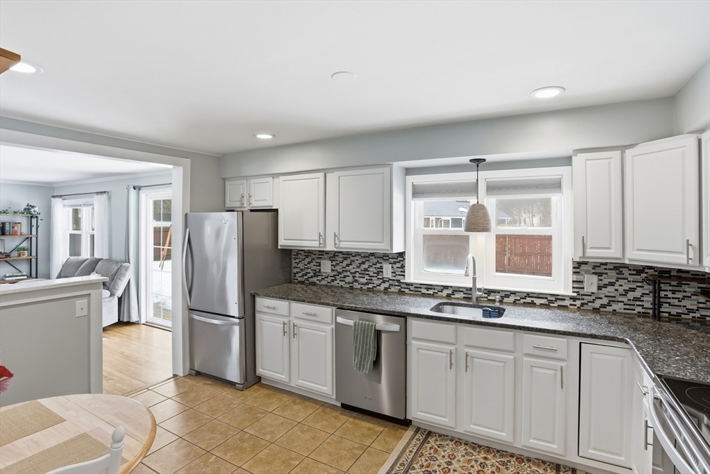 37 Sterling Street Lancaster, MA 01523 - Photo 9 of 33 a kitchen with a refrigerator sink and cabinets
