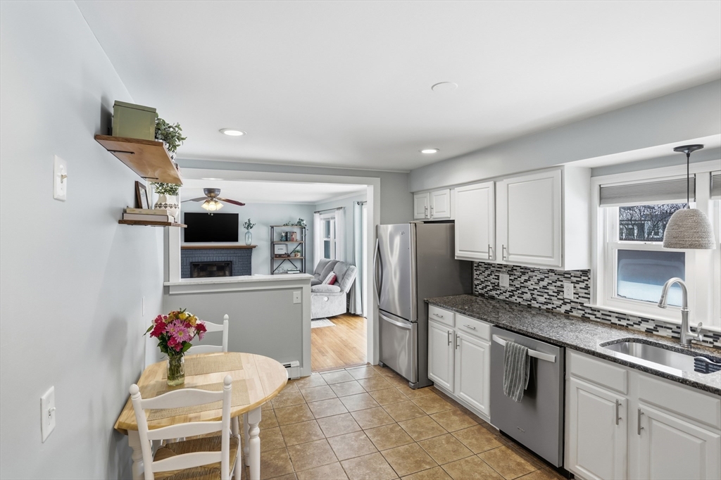 37 Sterling Street Lancaster, MA 01523 - Photo 10 of 33 a kitchen with stainless steel appliances kitchen island granite countertop a sink refrigerator and microwave