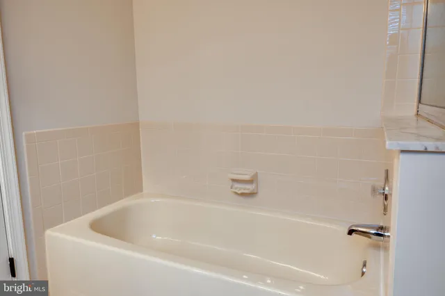 a white bath tub and shower