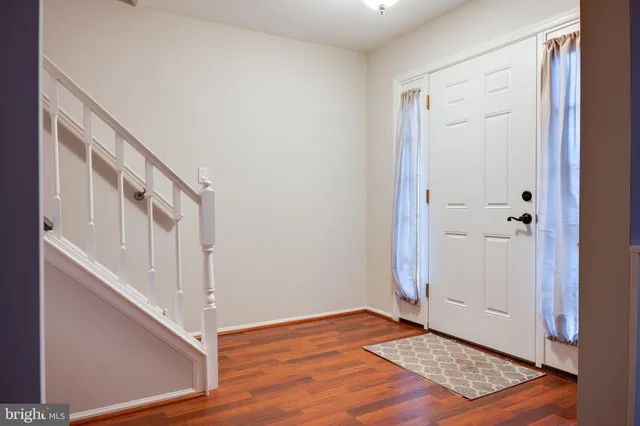 a view of an entryway with wooden floor