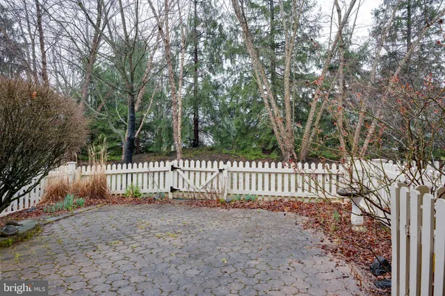 a view of a deck with a fence and trees